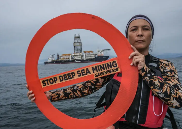 Malaysian actress Sharifah Sofia holds a forbidden sign in front of the deep-sea vessel “Hidden Gem” which is anchored at sea in Labuan, Malaysia. The Hidden Gem, owned by AllSeas and commissioned by The Metals Company, is the deep-sea mining industry’s flagship vessel. It is currently in Labuan, Malaysia, in long-term storage. The Metals Company confirmed in late April that they have submitted the first-ever commercial mining application to the US government, with the company stating they are “ready to go”.